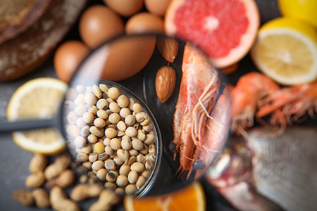 Different products with magnifier focused on soy beans and shrim