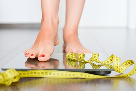 Perfect silhouette concept with woman on a weight scale